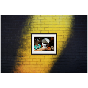 Framed Photo Print Poster "It's Coffee Time!" on black and yellow brick wall. Shows a vintage enamel coffee mug. Photography by Jacob Sellström. Printed on matte paper with wooden frame. Two sizes: 8x10, 12x16.