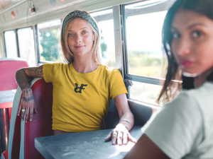 Vintage girls in diner van in cali, wearing black & yellow t-shirt with "RIF" Roast In Focus logo. Comfortable cotton. Sizes S-XL. Logo collection.