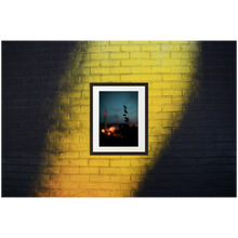 Framed Photo Print Poster "Stockholm in Bokeh" on a black & yellow brick wall. Shows a bokeh version of the city shot from a vantage point. Moody Photography by Jacob Sellström. Printed on matte paper with wooden frame. Two sizes: 8x10, 12x16.