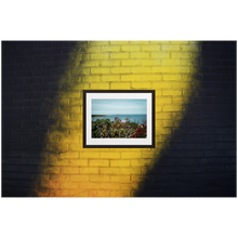 Framed Photo Print Poster "Swedish Archipelago" on black & yellow brick wall. Shows beautiful views of the archipelago of Gothenburg, shot from a vantage point. Photography by Jacob Sellström. Printed on matte paper with wooden frame. Two sizes: 8x10, 12x16.