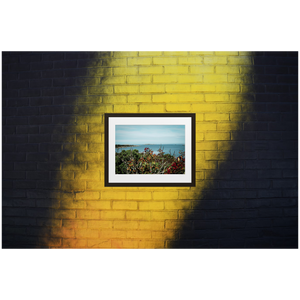 Framed Photo Print Poster "Swedish Archipelago" on black & yellow brick wall. Shows beautiful views of the archipelago of Gothenburg, shot from a vantage point. Photography by Jacob Sellström. Printed on matte paper with wooden frame. Two sizes: 8x10, 12x16.