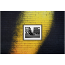 Framed Black & White Photo Print Poster "Tunnel Vision" on black and yellow brick wall. Motorcycle panning shot in Stockholm, Sweden. Photography by Jacob Sellström. Printed on matte paper with wooden frame. Two sizes: 8x10, 12x16.