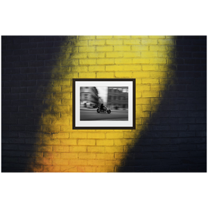 Framed Black & White Photo Print Poster "Tunnel Vision" on black and yellow brick wall. Motorcycle panning shot in Stockholm, Sweden. Photography by Jacob Sellström. Printed on matte paper with wooden frame. Two sizes: 8x10, 12x16.