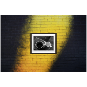 Framed Black & White Photo Print Poster "Yin & Yang" on black and yellow brick wall. Shows coffee and milk as ying and yang. Photography by Jacob Sellström. Printed on matte paper with wooden frame. Two sizes: 8x10, 12x16.