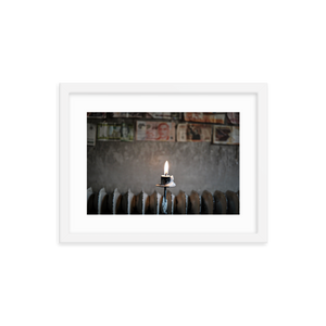 Framed Photo Print Poster "Flame Of Hope". Shows a burning candle with different currency bills in the background. Shot at a cafe is Stockholm. Photography by Jacob Sellström. Printed on matte paper with wooden frame. Two sizes: 8x10, 12x16.